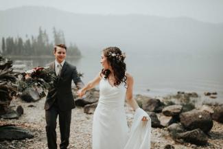 Married couple in front of lake.