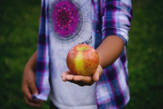 Teenager holding apple